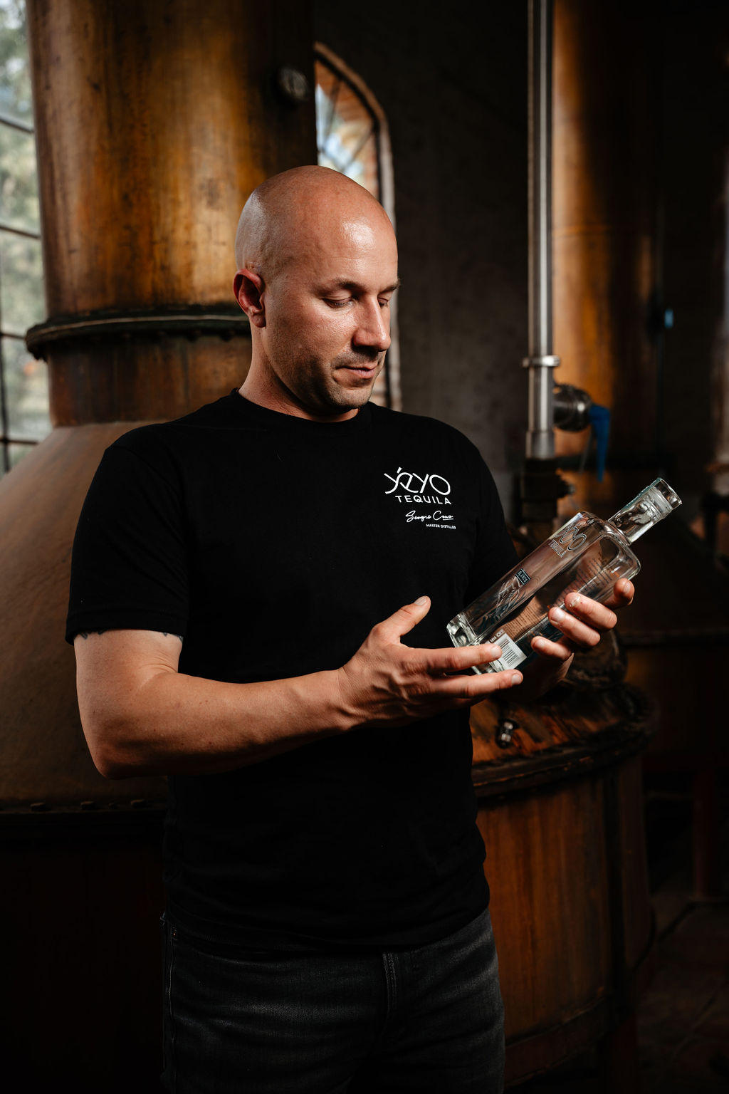 Yéyo founder Jon Bullinger looking at a Yéyo bottle at the distillery