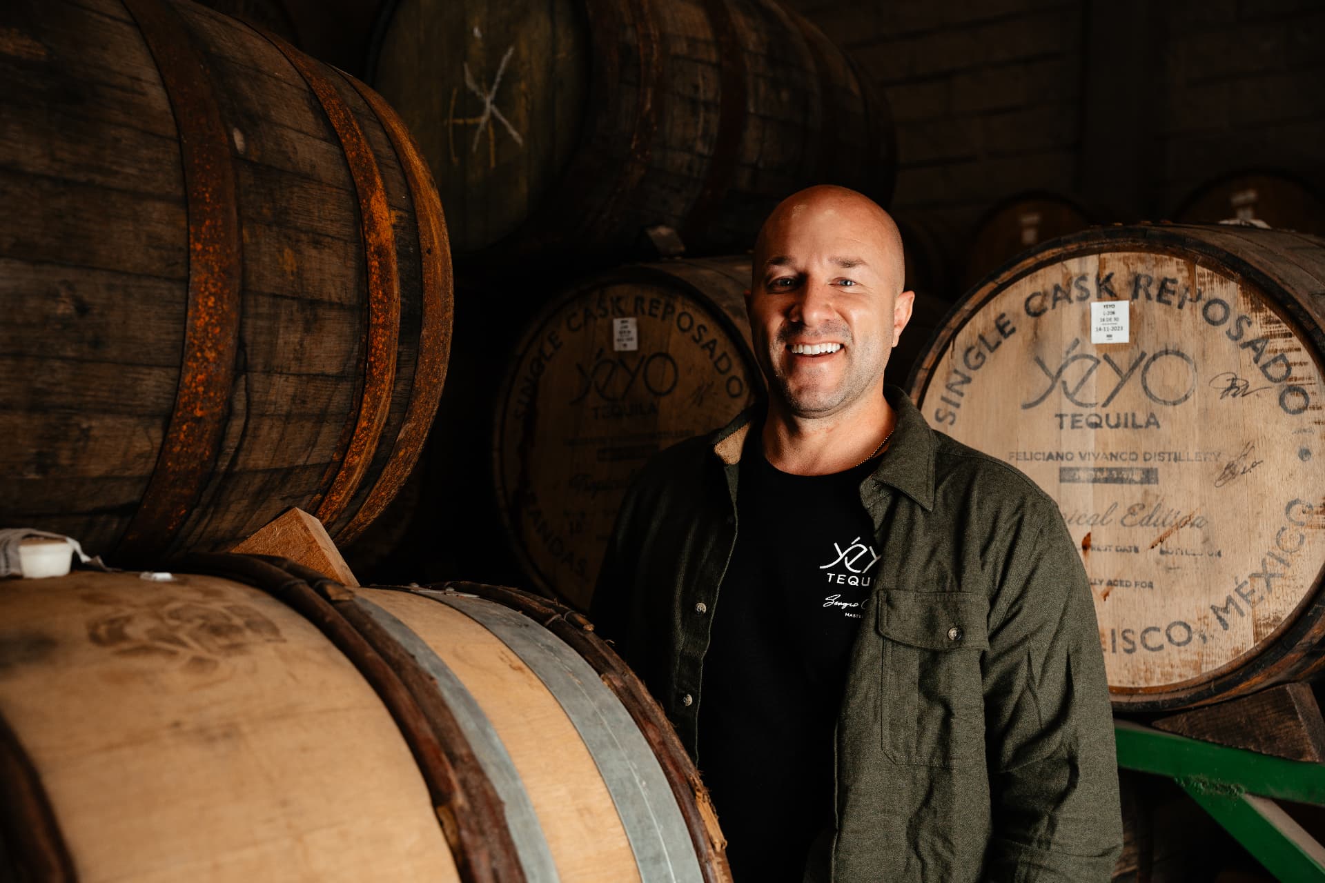 Yéyo team member standing among marked Yéyo barrels