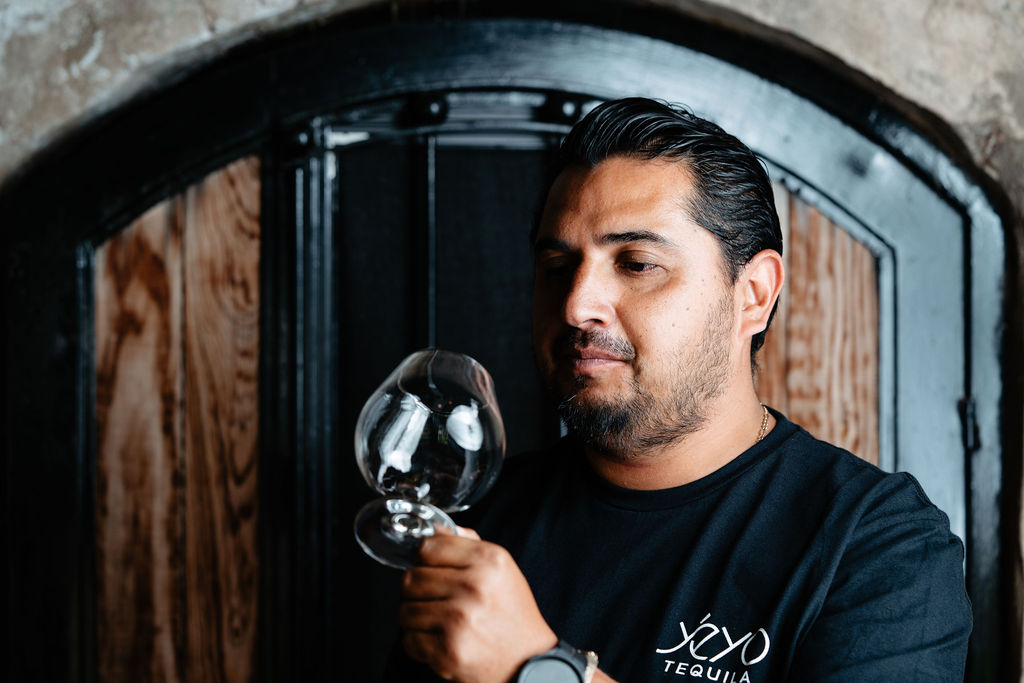 Sergio Cruz, Yéyo's Master Distiller, examining a glass of tequila at the distillery
