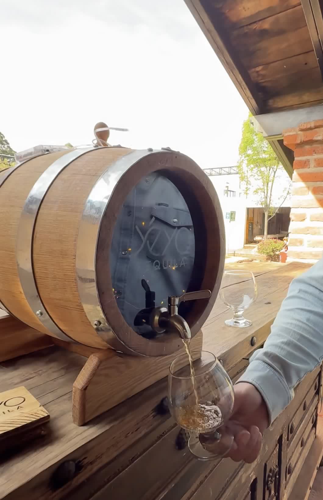Tequila being poured from the Infinity Barrel into a glass at the distillery